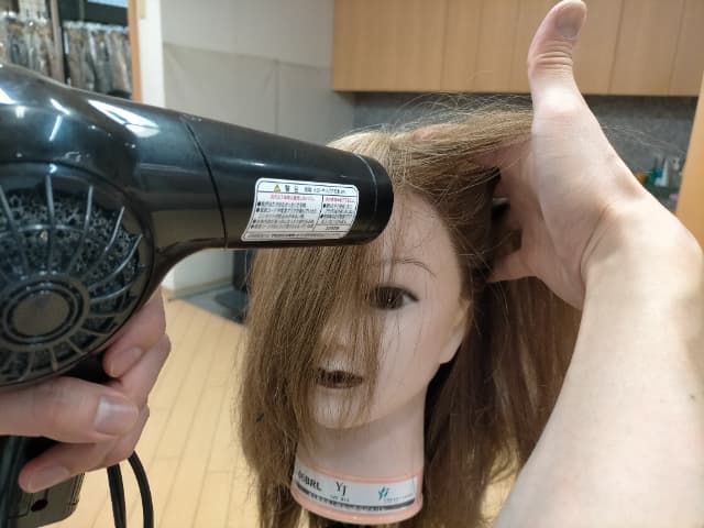 指を使ってドライヤーで乾かしているところ