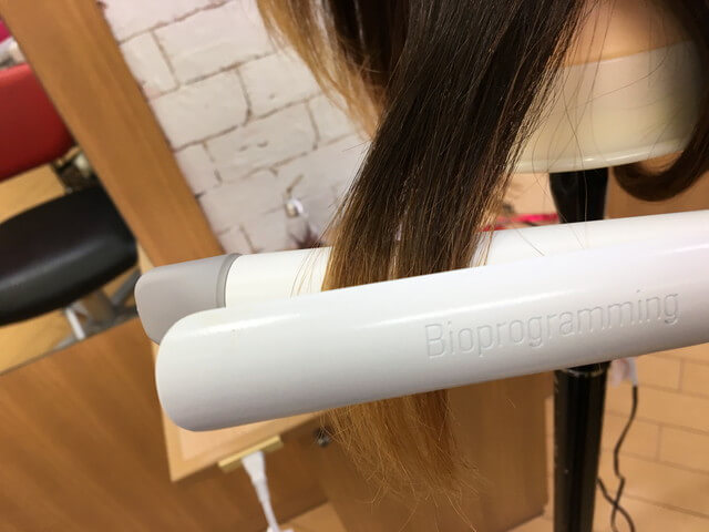 ヘアビューロンカールで髪の毛を挟むところの写真